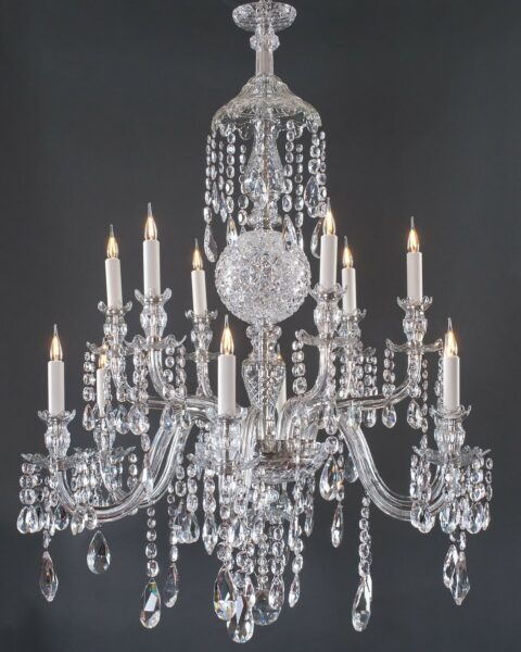 This fine quality crystal chandelier in the manner of Perry & Co is Circa late 19th Century. This beautiful chandelier has 12 faceted cut arms and drops, a stunning central cut glass ball and ornate bobeches.