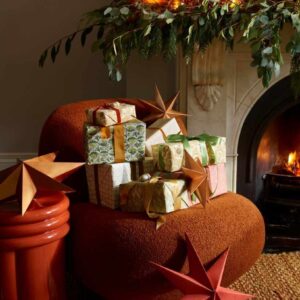 House beautiful  Christmas living room chair with presents detail 